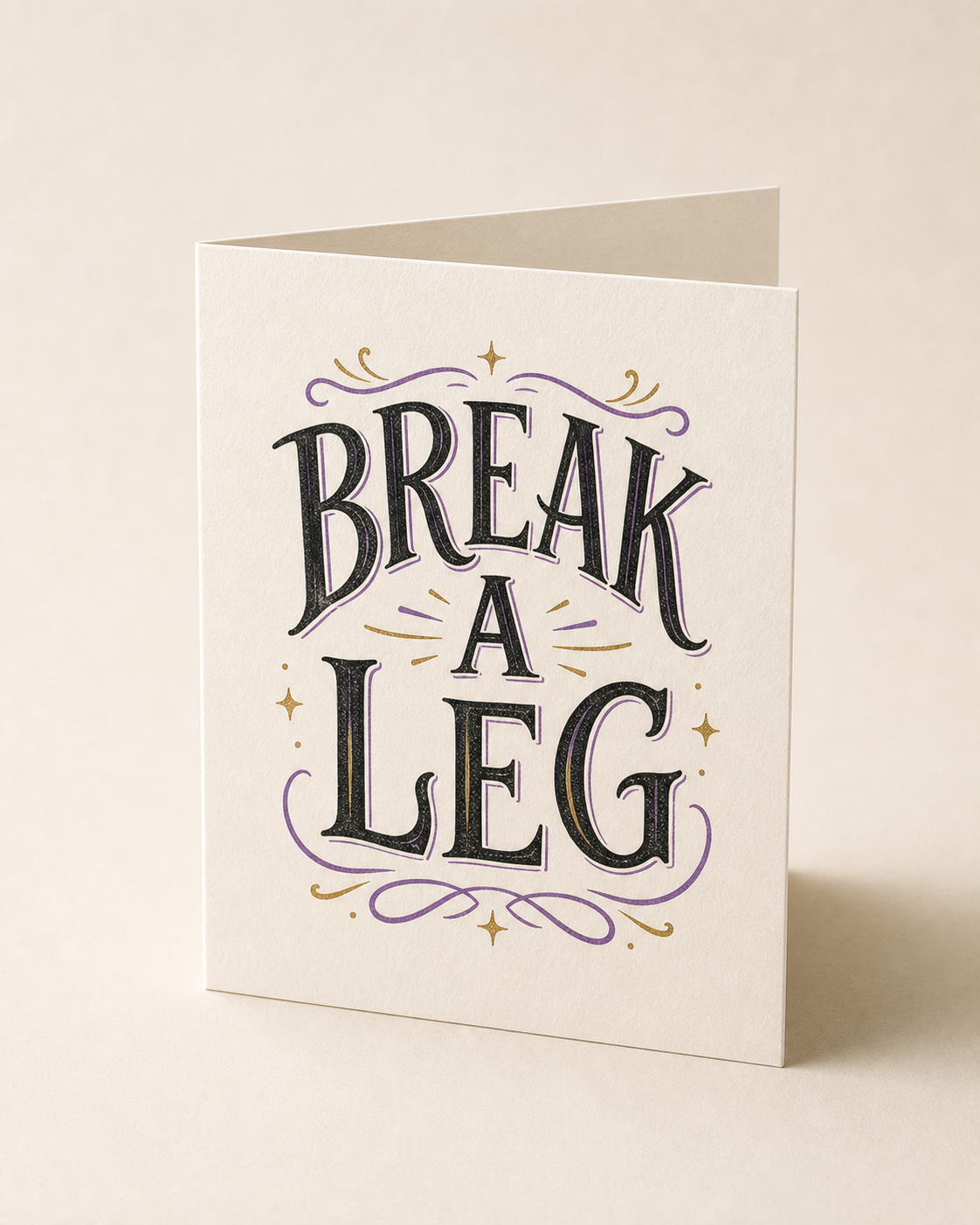 A folded greeting card hand-lettered Break a Leg in theatrical type.