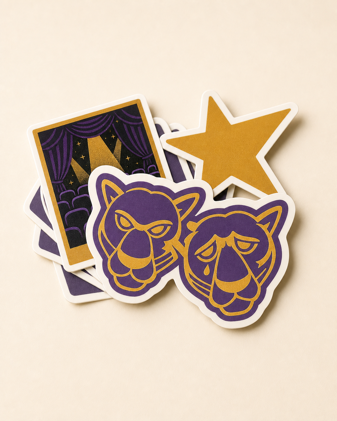 A fan of die-cut vinyl stickers including the Panther comedy and tragedy crest and a star.