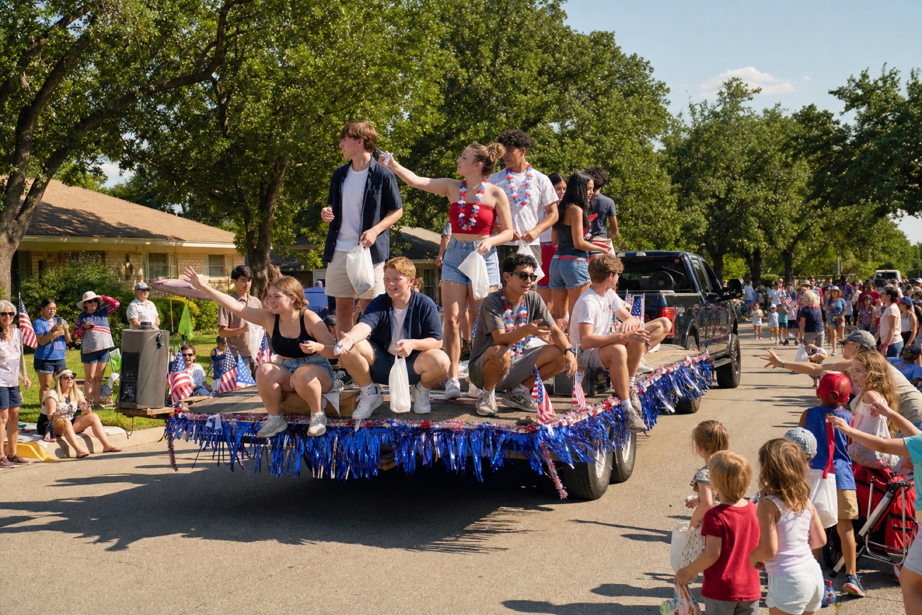 Vagabonds on a small parade float waving to neighbors in the Ryan Place neighborhood on the Fourth of July.
